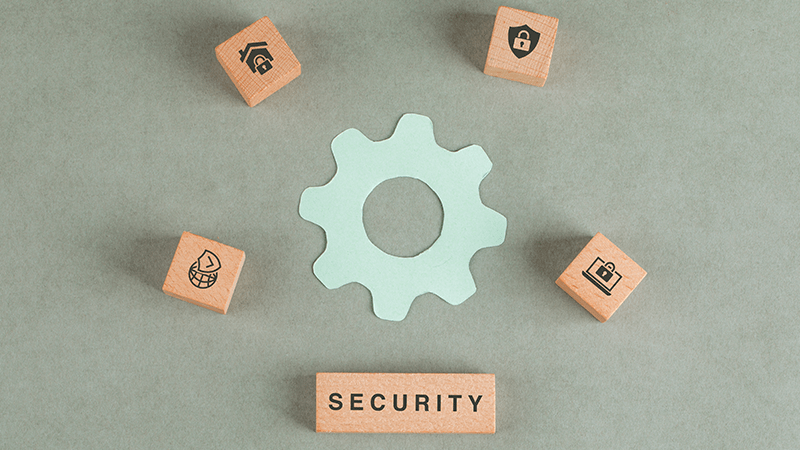 gear icon surrounded by wooden blocks with data security icons in a circle 