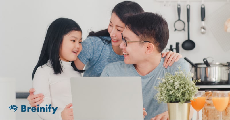 Asian family using computer and talking