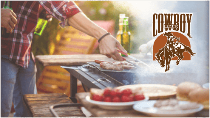 Person preparing food over charcoal grill, with Cowboy Charcoal brand logo.